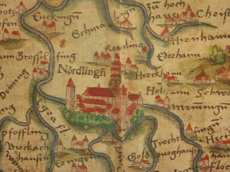 A detailed map of Nordlingen, Germany, highlighting city districts, surrounding towns, and landscape, with embedded images of buildings and trees, and text providing additional information about the city and its inhabitants.