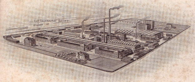 Black and white aerial drawing of a German city with varied buildings, green trees, and chimneys emitting smoke, labeled "Luftaufnahme Werkt, Germany."