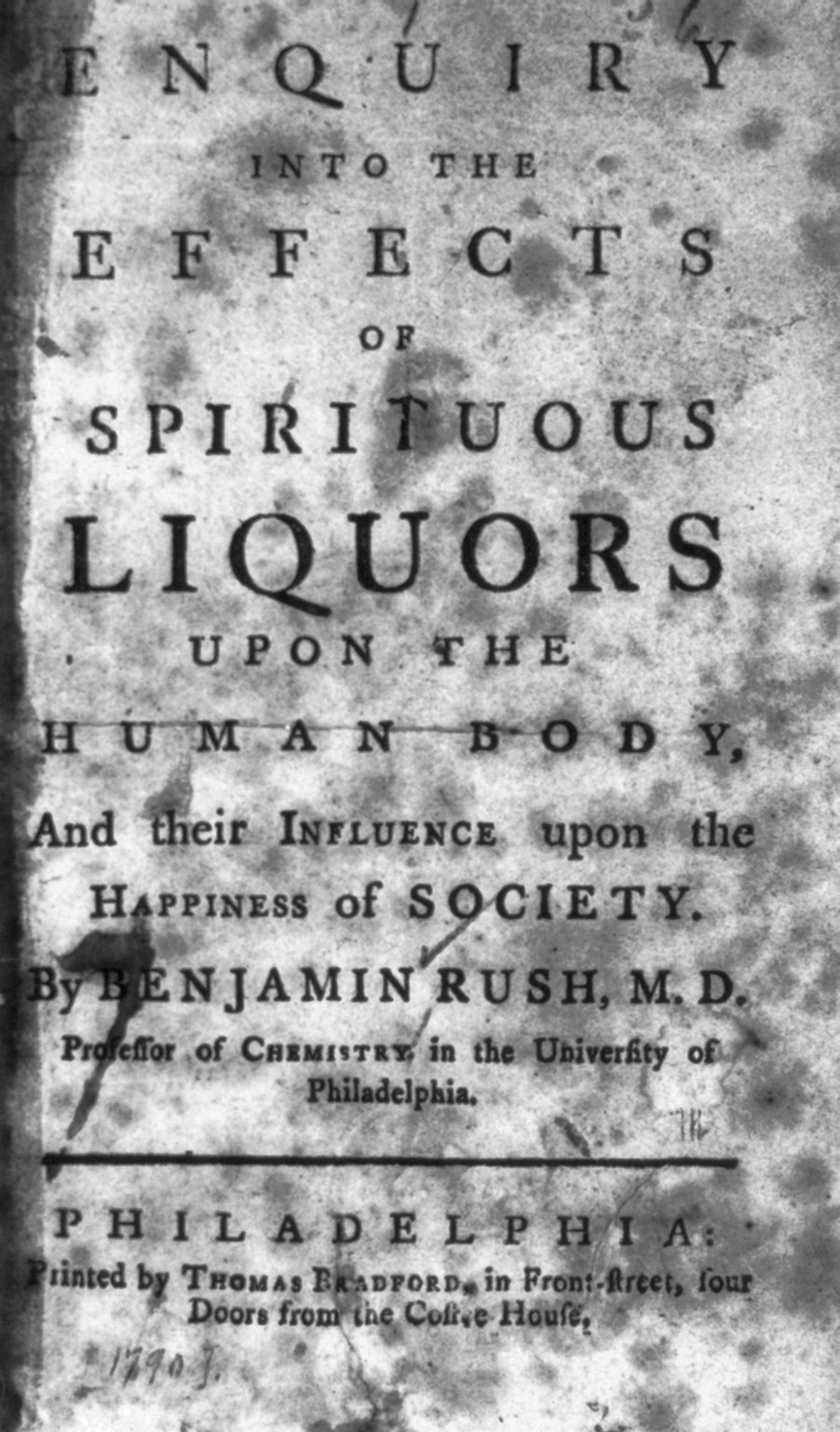 Old book titled "Enquiry into the Effects of Spiritual Liquors Upon the Human Body and Their Influence Upon the Happiness of Society" with likely essay content on liquor's effects.
