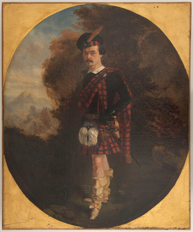 Ein Mann in traditioneller schottischer Kleidung, bestehend aus einem roten und schwarzen Tartan-Kilt, weißem Hemd und schwarzem Gürtel, steht mit ernster Miene vor einem Hintergrund aus Bäumen und Himmel.