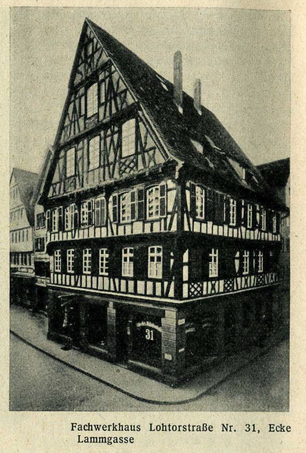 Black and white photograph of a half-timbered building at Lohtorstraße 31, Eke, with the street and sky visible behind it.