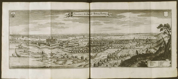 Open book with a detailed map of Berlin, Germany, featuring a city surrounded by trees and buildings under a cloudy sky.