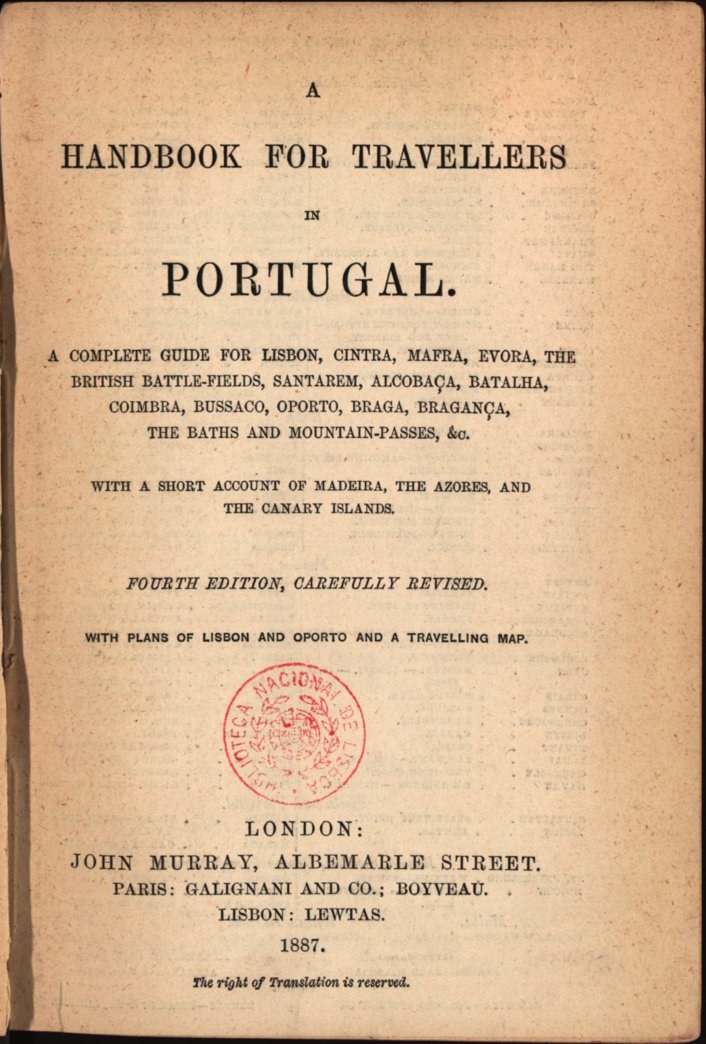 A handbook for travelers in Portugal, open to a page featuring a detailed map of Portugal with text in traditional Portuguese font, and a red circular stamp with a white border on the cover.